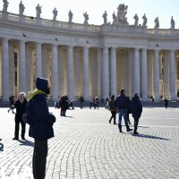 Winter day in ancient Vatican with modern people